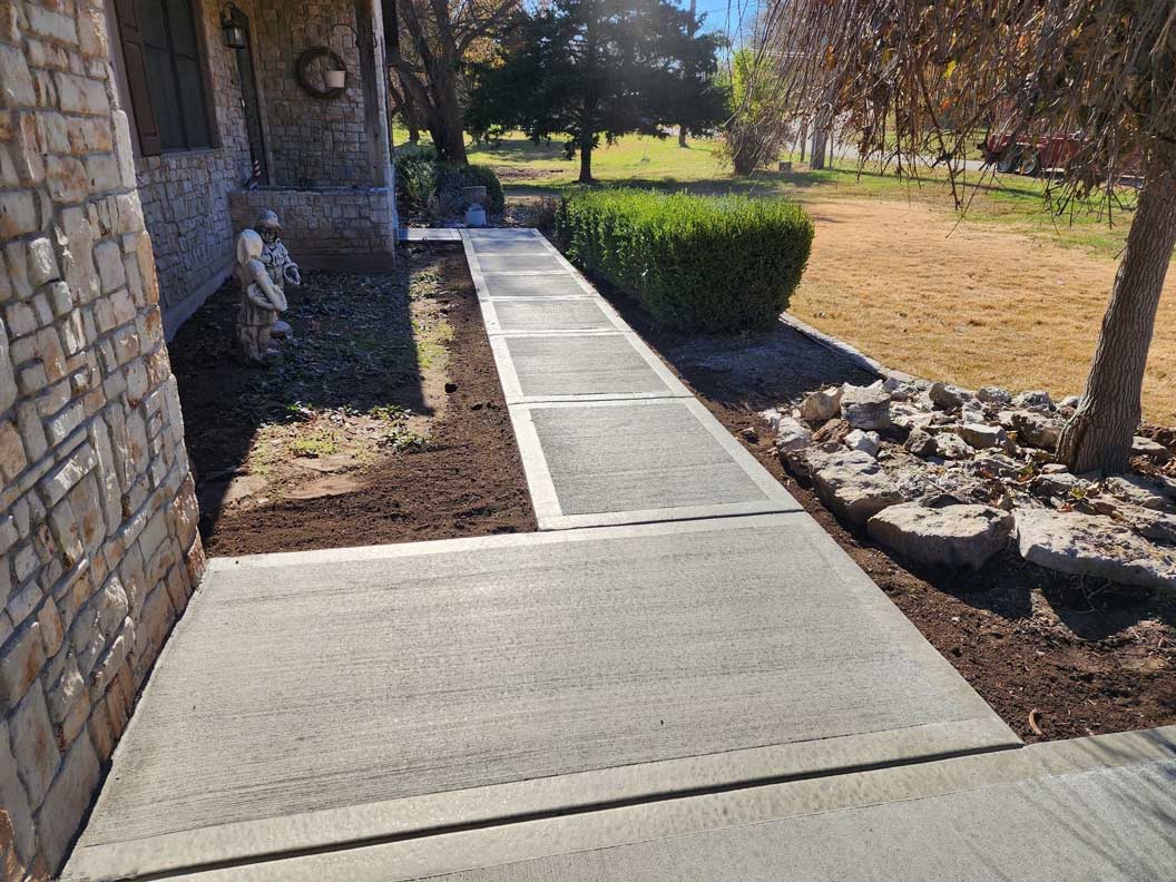 Broom-finish concrete walkway at a residential property in Kansas City Northland
