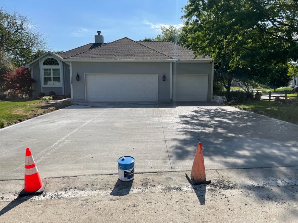 Finished three-car concrete driveway — residential project in Kansas City Northland